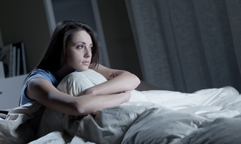 Woman staring out from bed