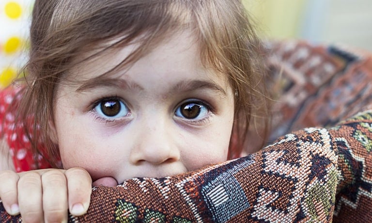 Girl cowering in basket