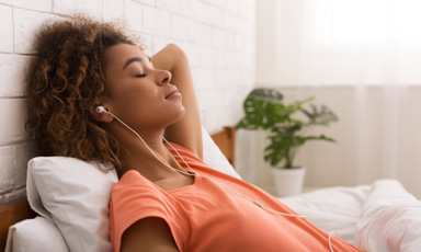 Woman relaxing with earbuds