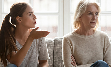  Annoyed grown-up daughter expressing complaints to elderly mother