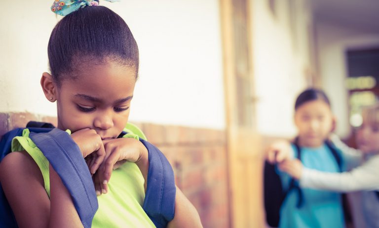 Girl bullied by classmates in school corridor
