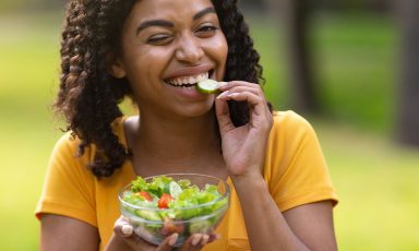 Girl eating fresh vegetable salad