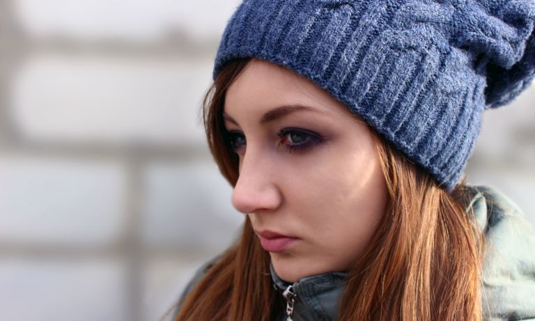 Closeup of teen girl with brooding expression